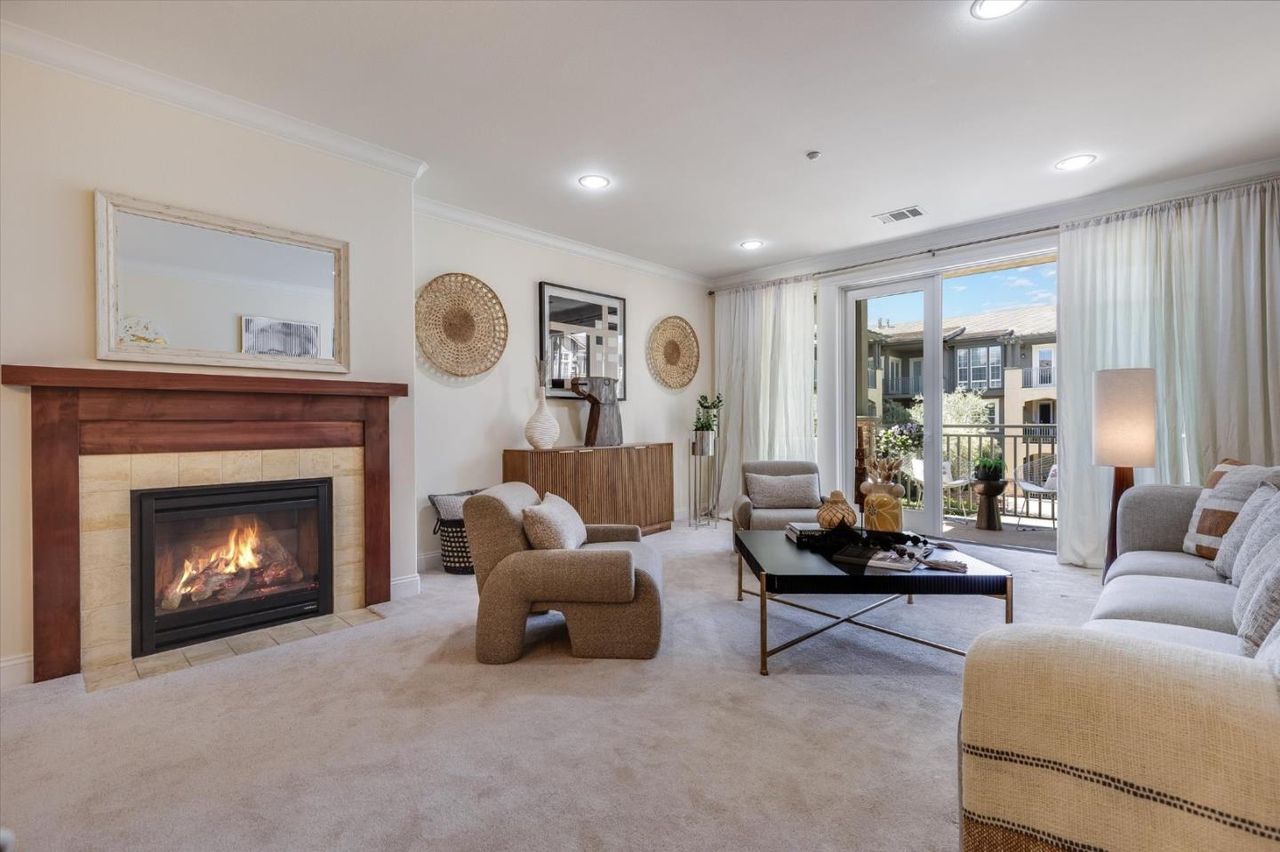 Living room with the fireplace lit at 2881 Meridian Ave Unit 249